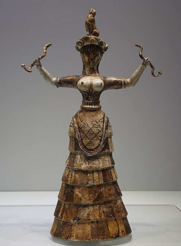 Minoan snake goddess figurine from Crete, holding confronted snakes, dated 1600 BC.