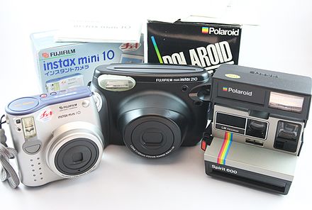 One Polaroid and two Fujifilm instant cameras with film