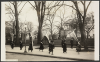 Young woman roller skating beside a group of women's suffragists at the White House, 1917