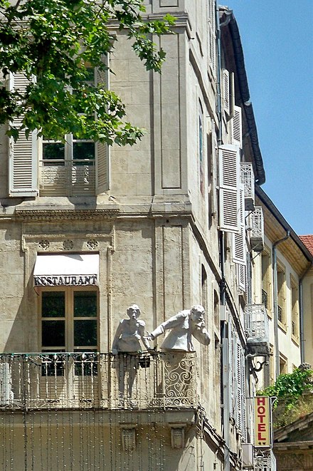 Statues gaze over the Place de l'Horloge in the town centre