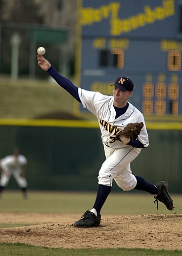 A Navy pitcher releases the baseball from the pitcher's mound.