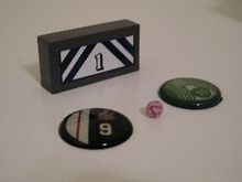 Typical ball, buttons, and goaltender game pieces Bfpieces.png