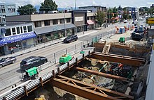 "Traffic decks" were built atop station construction sites to avoid road closures. Broadway Subway construction near Yukon Street, Vancouver - July 2022 - 02.jpg