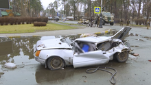 A corpse inside a crushed car in Bucha, 2 April 2022 DestroyedcarinBucha.png