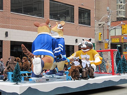Parade float featuring the logo for Timbits, a Tim Hortons product, on the raccoon playing ice hockey at the Toronto Santa Claus Parade