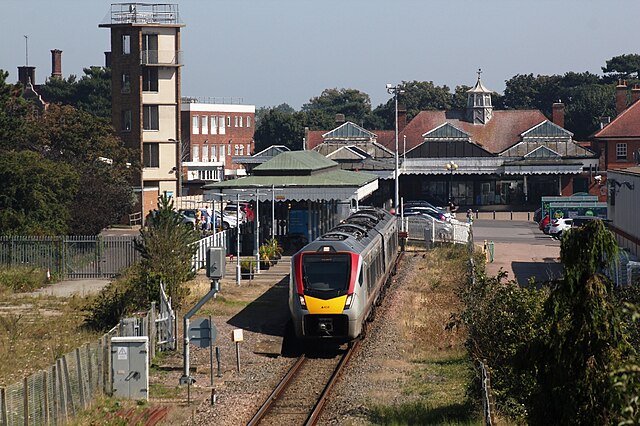 A Class 755 train for Ipswich leaves the one remaining and shortened platform, with the old station buildings in the right background.