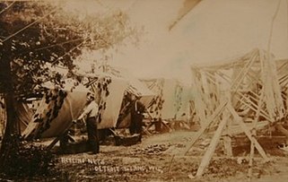 Fishermen working with nets on Detroit Island; from a postcard postmarked in 1909