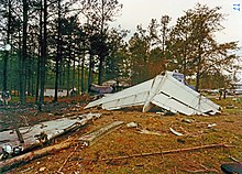 The remnants of the tail section, with the separated right wing in the foreground. Flight 242 tail and wing.jpg