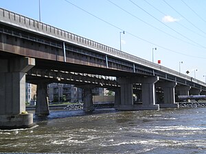 Two non-identical box girder bridges over rapids.