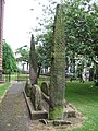 Image 23'Giants Grave', St. Andrew's churchyard, Penrith, an unusual arrangement of two Viking-age cross-shafts with four hogbacks (in the foreground). In addition, there is a smaller, Viking-age, wheel-headed cross just visible in the background (from History of Cumbria)