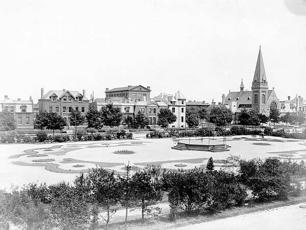 Arcade Park in Pullman surrounded by picturesque buildings in historical styles, including the Gothic Revival Greenstone Church.