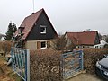 Residential house in a settlement, with enclosure