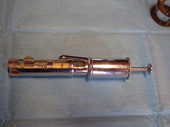 English: an early insulin pen ("Painless ...