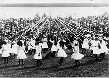 May Day celebrations in 1913. Young girls dance around a maypole.