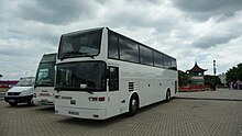 Autocar de tourisme de couleur blanc sur un parking.