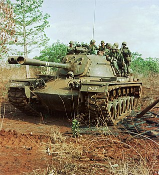 Tank carrying soldiers