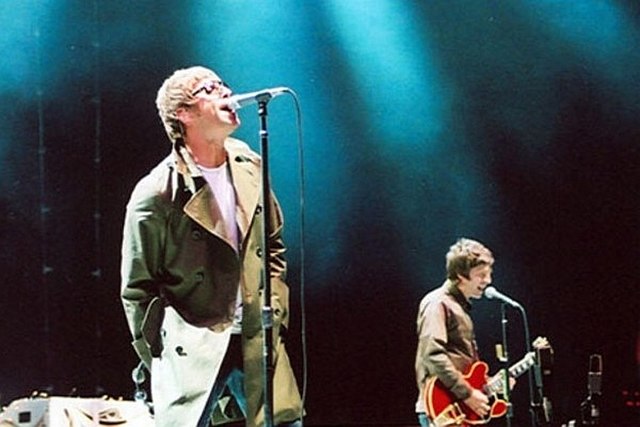 Lead singer Liam Gallagher and songwriter and lead guitarist Noel Gallagher performing in 2005