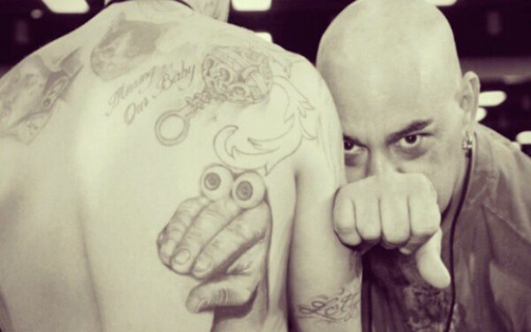 Artist Jesse Hernandez with an Oobi tattoo in Longview, Texas.