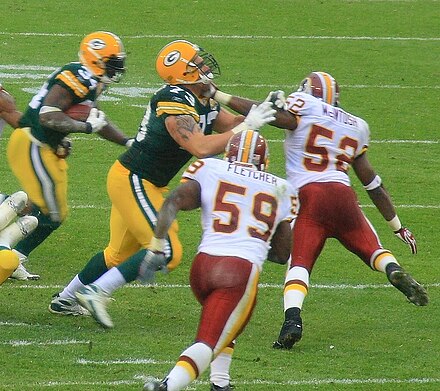 Fletcher (#59) pursuing Vernand Morency with Rocky McIntosh (#52) in 2007 season.