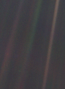 Earth (Q2) seen by Voyager (Q155257) from 6 billion kilometers as a "Pale Blue Dot (Q474472)" (the blueish-white speck in the brown band to the right)