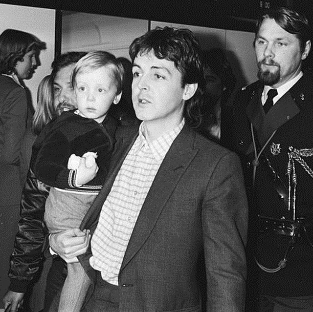 Two-year-old James in 1980, carried by his father Paul McCartney