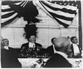 President Taft at dinner, with eagle and U.S. flag behind him LCCN92519793.jpg