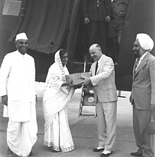 Ninety-three cases of penicillin, a gift from the Canadian Red Cross to India arrived at New Delhi in a special plane from Canada on 17 October 1947. Presenting the gift to Amrit Kaur, the then Health Minister in the Government of India at the Palam aerodrome. Jivraj Narayan Mehta, Director General of Health Services appears on the left and standing on the right is Sardar Balwant Singh Puri of the Indian Red Cross. Rajkumari Amrit Kaur receiving penicillin cases.jpg