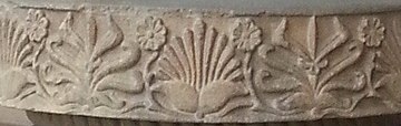 Rampurva bull capital, detail of the abacus, with two "flame palmettes" framing a lotus surrounded by small rosette flowers.