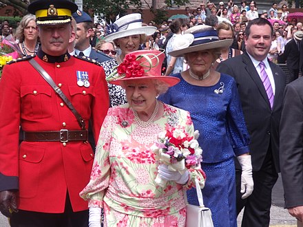 Queen Elizabeth II (centre) followed by the Queen's Police Officer (left), drawn from the Royal Canadian Mounted Police