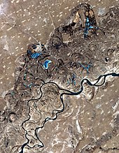 Meanders, scroll-bars and oxbow lakes in the Songhua River SonghuaRiver ASTER 20020401.jpg