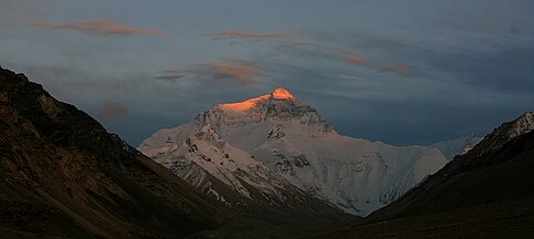 Sunset lights up the peak of Everest's North face