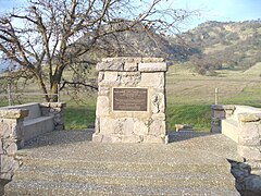A monument at the base of the mountains indicating that John C. Fremont camped near here