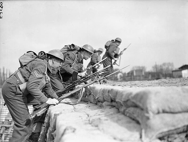 Guardsmen of King's Company, 1st Battalion, Grenadier Guards go 'over the top' during training at Annappes, France, 8 April 1940.