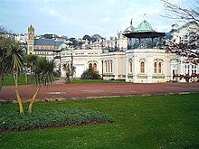 Torquay Pavilion, with St John's Church in the background and a cabbage tree in the foreground