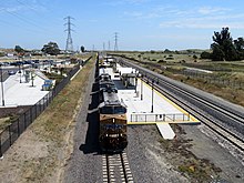 A Union Pacific freight train passes through Fairfield-Vacaville Amtrak station, May 2019 UP freight train at Fairfield-Vacaville station, May 2019.JPG