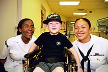 Navy Reservists from the USS Frederick visiting an Oregon hospital in June 2002 US Navy 020607-N-9022M-001 visit with children at Portland Shiners Hospital.jpg