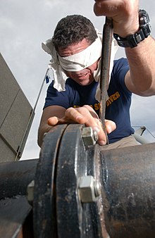 A navy diver practices mechanical work while blindfolded to simulate a low visibility environment US Navy 030220-N-5862D-079 practicing building a flange while blindfolded.jpg