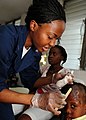 "US_Navy_100205-N-6676S-001_A_corpsman_applies_an_anti-bacterial_ointment_to_the_upper_forehead_of_a_Haitian_child.jpg" by User:BotMultichillT