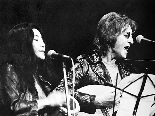 Ono and Lennon performing at a rally in December 1971