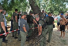 Odesa "Municipal Guard" dismantles the decorative fence on the territory of the "Pavlovs' House" Gostiny Dvor Odesskaia Munitsipal'naia strazha.jpg