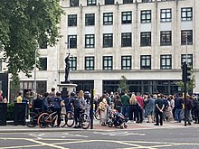 A crowd observing the statue