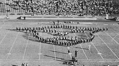 During the 1950s, the Pitt Band, shown here during the 1952 Pitt football season, would close halftime shows playing the "Alma Mater" in the Panther Head formation BandAlmaMaterPH.jpg