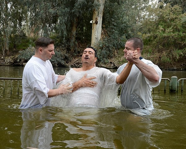 A baptism by immersion in the Jordan River.