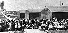 Internees in front of barracks