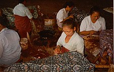 Batik craftswomen in Java handmarking resist on batik tulis cloth with tjantings.jpg