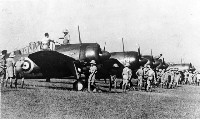 Brewster Buffalo Mark Is from No. 453 Squadron RAAF being inspected by RAF personnel at Sembawang Airfield, Singapore on 12 October 1941.