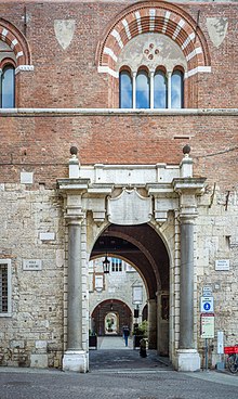 West Gate or Porta Orientale; carved template above door from Venetian rule, expunged in 1790s Broletto portale Brescia.jpg