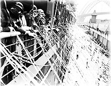 Passengers lining the rail of Cathay's deck holding farewell streamers in one of her departures from Circular Quay, Sydney, in the 1930s CATHAY departing from West Circular Quay with spectators and streamers, 1932-1939.jpg