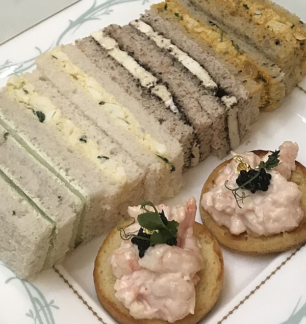 Finger sandwiches: cucumber, egg, cheese, curried chicken, with prawn canapés served during tea at the Savoy in London.