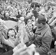 Dutch civilians celebrating the arrival of I Canadian Corps troops in Utrecht after the German surrender, 7 May 1945 Crowd of Dutch civilians celebrating the liberation of Utrecht by the Canadian Army.jpg